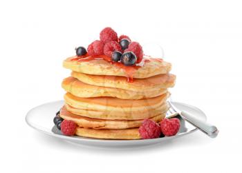 Plate with tasty pancakes and berries on white background�