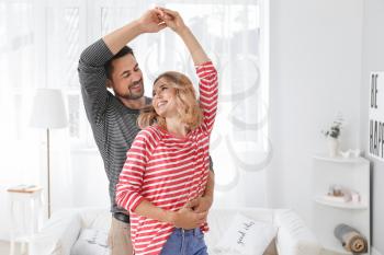 Happy dancing couple at home�