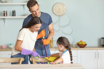Happy family cleaning kitchen together�