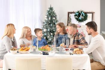 Happy family having Christmas dinner at home�