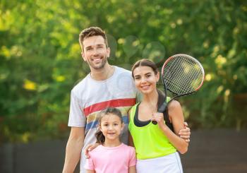 Happy family on tennis court�