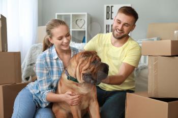 Happy couple with cute dog after moving into new house�