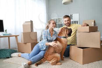 Happy couple with cute dog after moving into new house�