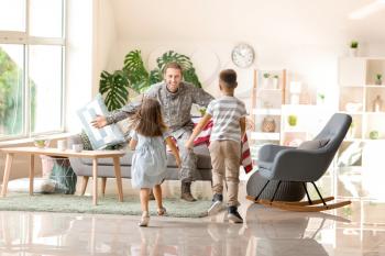 Happy children meeting their military father at home�