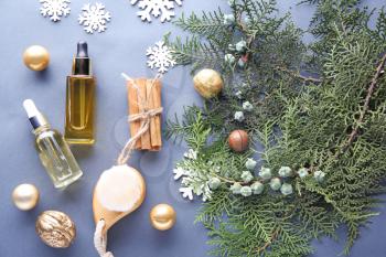 Christmas composition with essential oil for spa treatment on grey background�