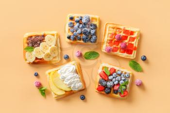 Tasty sweet waffles on color background�