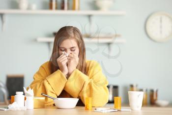 Sick woman at kitchen table�