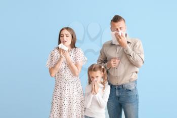Young family suffering from allergy on light background�