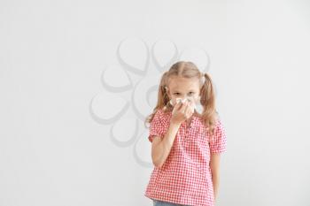 Little girl suffering from allergy on light background�