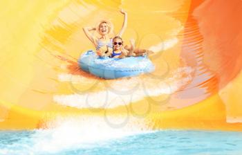 Little girl and her mother having fun in aqua park�