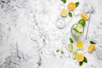 Glass of fresh mojito with ingredients on white background�