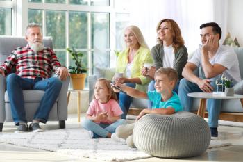 Big family watching TV together at home�
