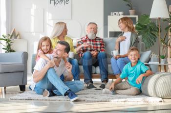 Big family watching TV together at home�