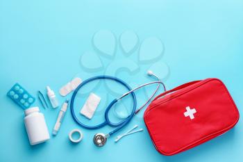First aid kit on color background�