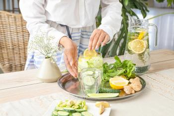 Woman preparing healthy infused water�