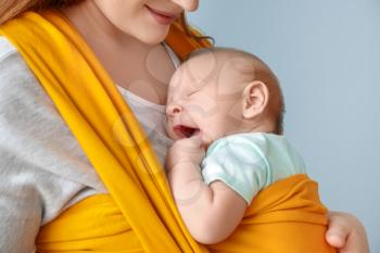 Mother with cute baby on color background, closeup�