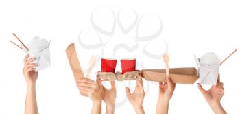 Many hands with food containers and cups on white background�