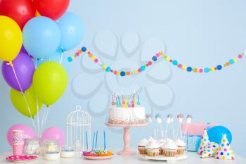 Tasty candy bar for Birthday party on table against color background�