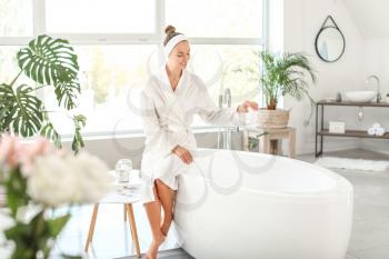 Beautiful young woman preparing relaxing bath�