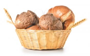Basket with fresh bakery products on white background�