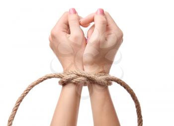 Female hands tied with rope on white background�