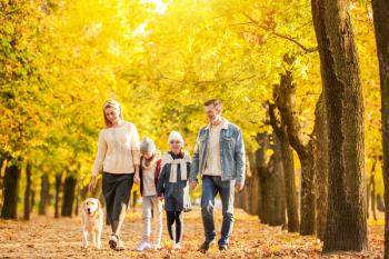 Happy family walking in autumn park�