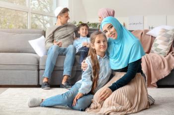 Portrait of happy Muslim family at home�