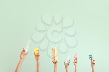 Hands with garbage on color background. Concept of recycling�