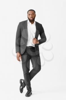 Stylish African-American man on white background�