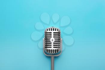 Retro microphone on color background�