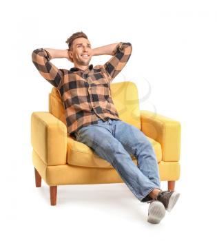 Handsome man sitting in armchair on white background�