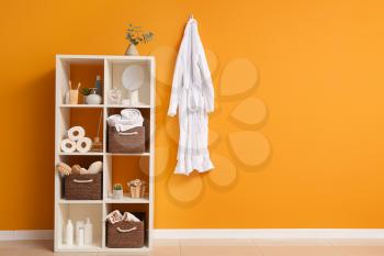 Body care cosmetics with accessories on rack in bathroom�