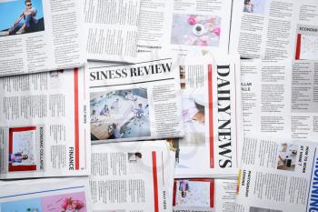 Many different newspapers as background�