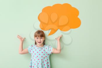 Cute little girl with blank speech bubble on color background�