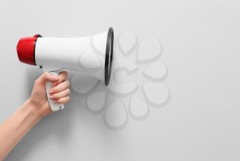 Female hand with megaphone on white background�