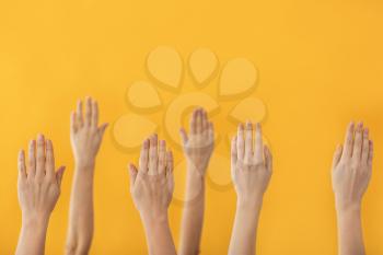 Hands of voting people on color background�