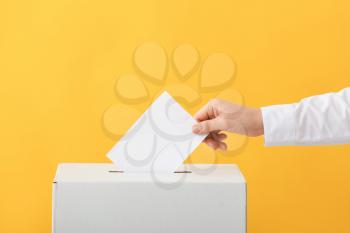 Voting woman near ballot box on color background�