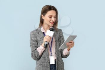 Female journalist on color background�