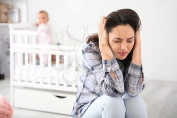 Young woman suffering from postnatal depression at home�