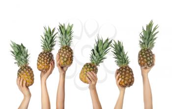 Hands with juicy pineapples on white background�