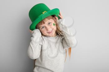 Funny little girl on white background. St. Patrick's Day celebration�