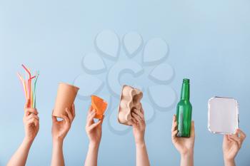 Hands with garbage on color background. Concept of recycling�