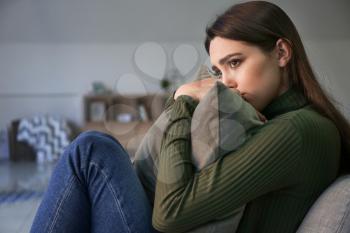 Depressed young woman at home�