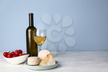 Fresh cheese with wine on white table�