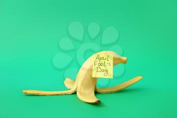 Banana peel on color background. April Fool's Day prank�