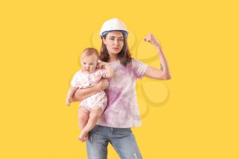 Young woman with baby on color background. Concept of feminism�