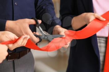 Man cutting red ribbon at the opening ceremony�
