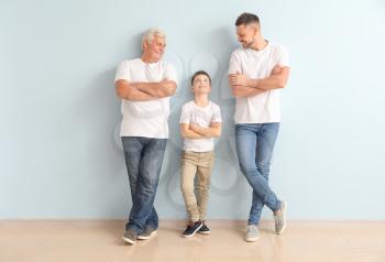 Man with his father and son near color wall�