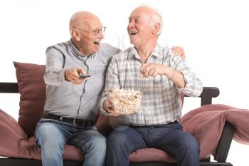 Portrait of elderly men watching TV on white background�