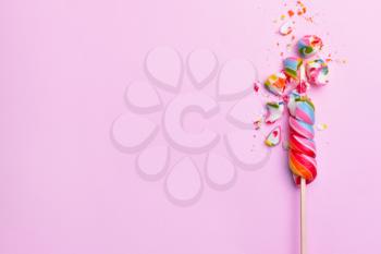 Crushed lollipop on color background�